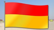 Eine rot-gelbe Flagge auf einem Strand © NDR 